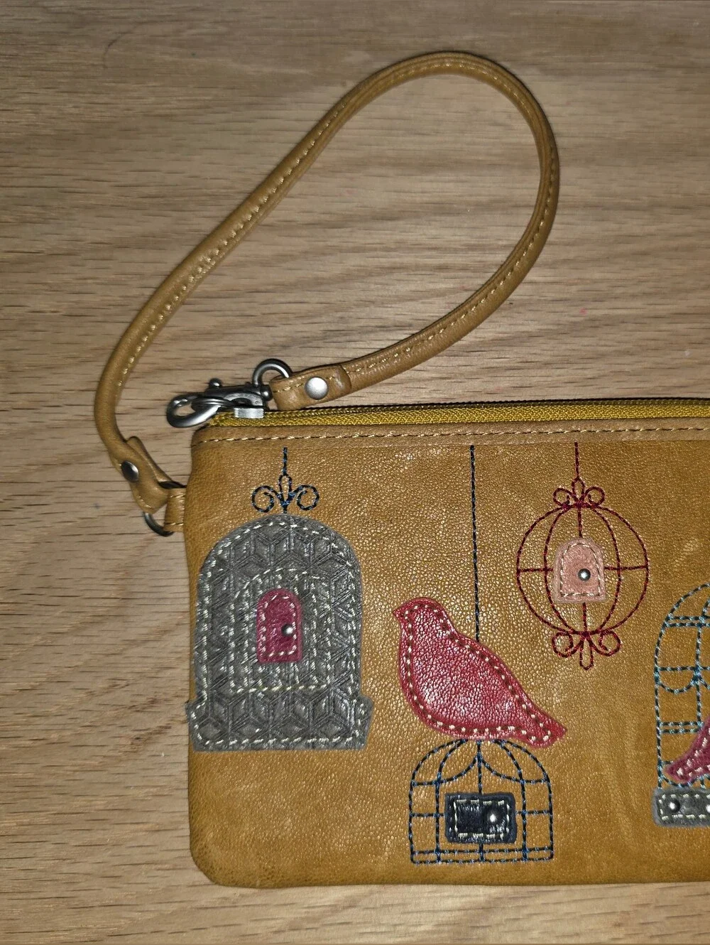 Fossil Mustard Yellow Wristlet with Embroidered Bird & Cage Motifs
